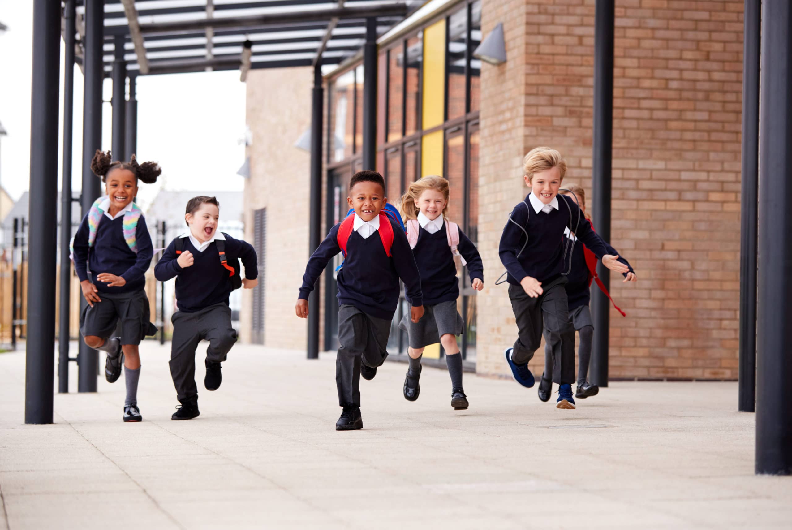 Five school children running