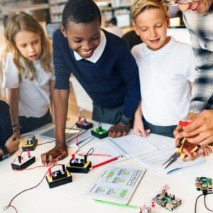 A group of school children and a teacher doing an experiment on a table